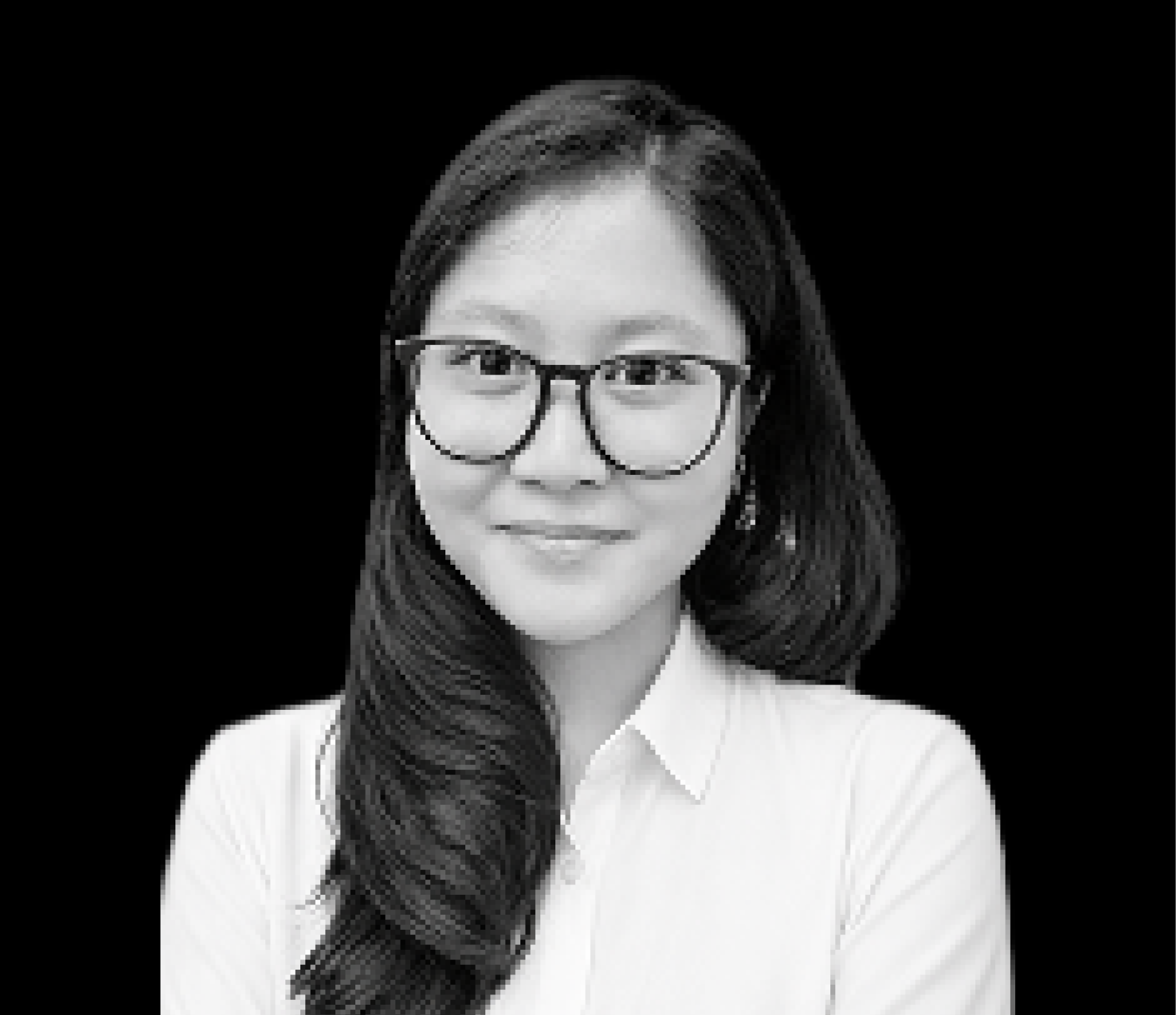 Smiling woman with glasses, long hair, and white shirt against a black background.